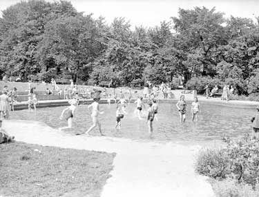 Children playing in paddling pool at Greenhead Park, Huddersfield 	
