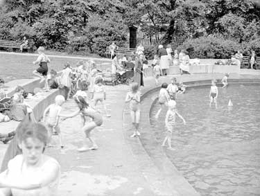 Children playing in paddling pool at Greenhead Park, Huddersfield 	