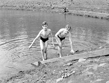 Two boys swimming 	