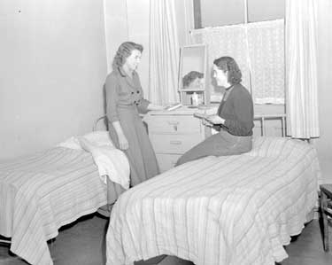 Two women in bedroom 	