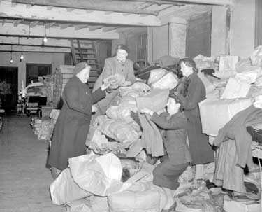Womens Voluntary Service sorting clothing at St. George Street clothing depot 	
