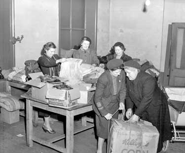 Womens Voluntary Service sorting clothing at George Street 	