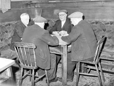 Men playing dominoes in pub at Scapegoat Hill, Huddersfield 	