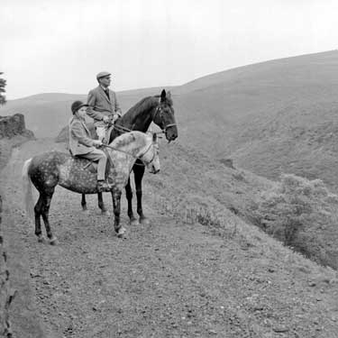 Man and girl on horses at Wessenden, Meltham, Huddersfield 	