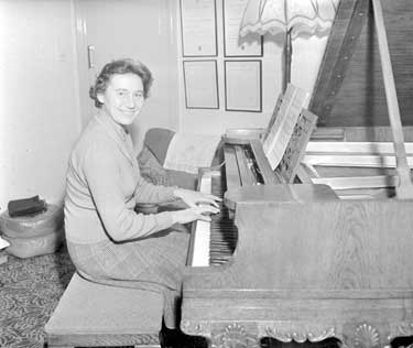Joan Sheard playing piano 	
