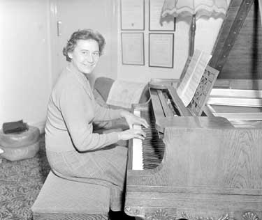 Joan Sheard playing piano 	