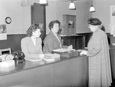 Women Staff in Huddersfield Railway Station Enquiry Office. Huddersfield Station had three women on its enquiry office staff in 1953. Miss Norma Pearson (centre) became a familiar and well-loved face at the Station, working there for over 40 years. 	