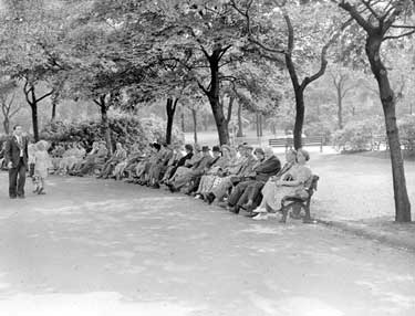 People sitting on benches, Greenhead Park 	