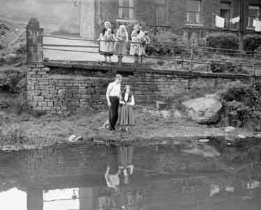 Couple fishing in canal at Milnsbridge, Huddersfield 	
