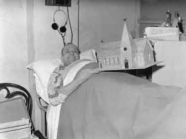 Man with model at Pinderfields Hospital, Wakefield 	