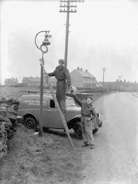 Men replacing lamps in Kirkburton, Huddersfield 	