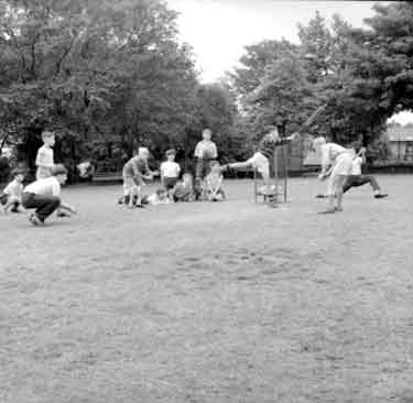Children playing cricket in Greenhead Park 	