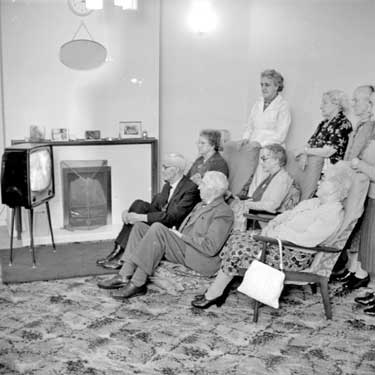 Older people watching television at Oakes Villa, Huddersfield 	
