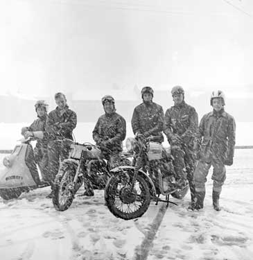Motorcyclists in the snow 	