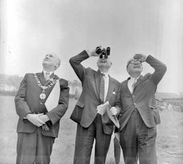 Lord Hull at Emley Moor TV mast with the Mayor, looking through binoculars.