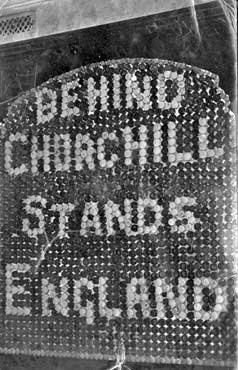 "Behind Churchill Stands England" - written out in coins.
