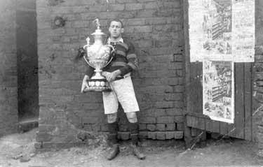 Man with rugby trophy