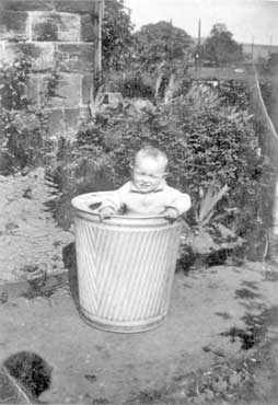 Photograph of Mrs Jessop as a child aged 3, in a dolly tub so her mother could keep an eye on her