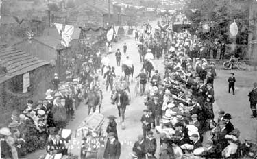 Kirkheaton Carnival: Liberal Club on right hand side; 1st wooden hut left hand side, Charlie Jessops Fish & Chips shop; 2nd hut left hand side, Cloggers Shop