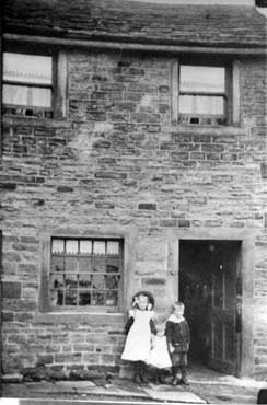 Emley Workhouse, Out Lane: standing outside are Hanna and Fred Smith (the Smiths are the last known family to have lived here). Emley Workhouse opened in 1803 and closed in 1835. The first year of ser