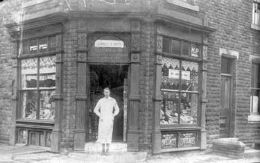Sybil Gunnell, mother of Jenny Staples (nee Broadbent), outside her shop, Gunnell & Smith Grocers, Beacon St/North Road, Ravensthorpe. The shop was bought for ?108 in 1933.