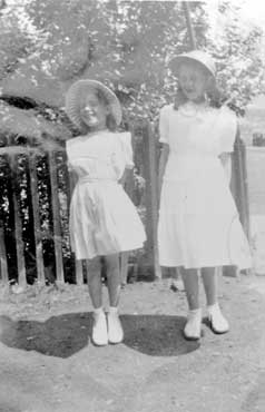 Maureen Holderness with friend, Christine, in Whit Monday clothes, Spen Valley Road, Ravensthorpe