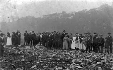 People gathered around watching a mill chimney being felled at T. Burnley & Sons, Checkheaton.