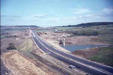 Construction of M62 across embankment of Scammondem Dam, (viewed from new bridge) Huddersfield