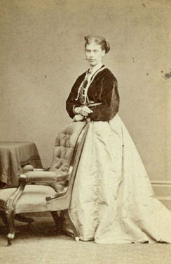 Portrait of a Young Woman, Standing by a Chair.