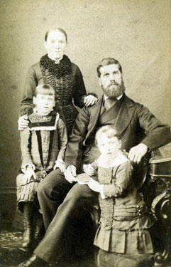 Portrait of a couple and their two young children.