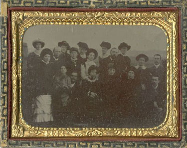 Group photograph in frame behind glass.