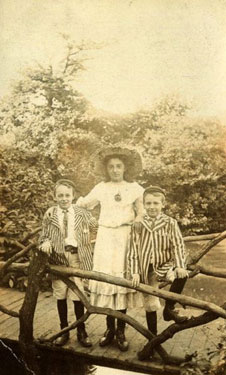 Young girl, Lizzie Bailey, with twin cousins George and Jimmy Bailey standing on a bridge.