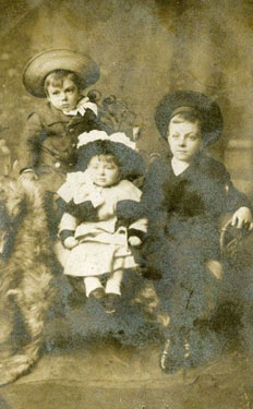 Studio image of three young children - Jimmy, Gilbert and Evie. (Christmas Card)