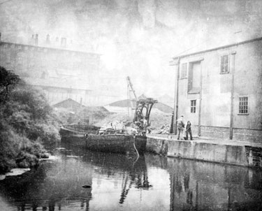 Barge at Aspley Basin, showing a dockside crane and a now demolished warehouse.