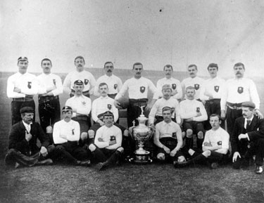 Rugby team photograph with cup.