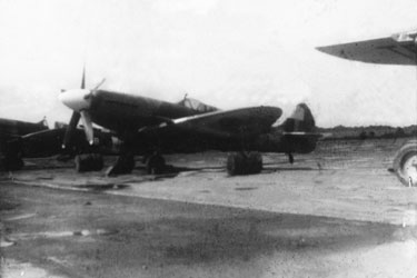 Wartime Archive of Reg Stone of Skelmanthorpe: Spitfire Fighter Plane, Mingaladon Airfield, Rangoon, Burma – “Drums of cement were used to anchor certain planes during the typhoon season.”