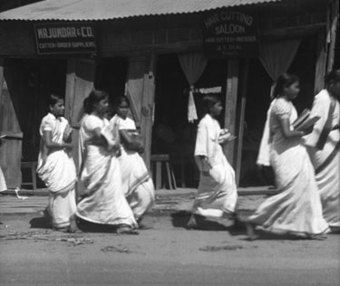 Royal Air Force 1543805 R.O. Stone East Bengal and Burma 1943-1946: Black and White Negatives of various photographs taken over that period – Girls from the near by Ladies’ Collage walking along Comilla’s Main Street, East Bengal.