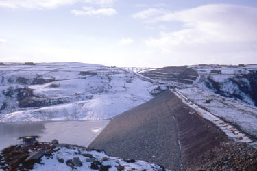 The construction of the first segment of the Yorkshire section of the M62 motorway, situated between the county boundary of Saddleworth Moor and Outlane - Scammonden dam/embankment in the snow.
