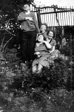 Photo Album Containing Various Images: Group Photograph in the Garden.