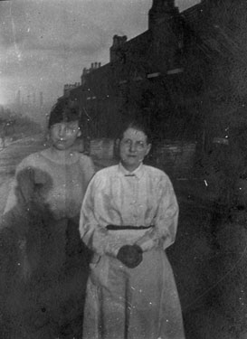 Edith Dyson standing in the street with her daughter.