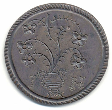 A bronze George III Irish halfpenny coin which has been polished on one side in order to produce a memento - on the other the original image has been partially left, but embellished; on the obverse an image of flowers in a vase with the initials J H; on the reverse is the name Josh Kinber, born Jan 19 1762 (which was a Tuesday).