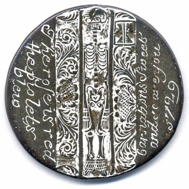A bronze William III halfpenny coin which has been polished on both sides in order to produce a love token; on one side are engraved the words 'The rose is red the violets blew [sic] Carnations sweet and so are you 1727', between them is a full-length skeleton - the design has been emphasised by the application of a white substance; the other side is blank.