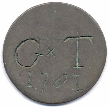 A bronze halfpenny coin which has been polished on both sides in order to produce a love token; on one side is engraved G x T above the date 1781; on the other side the frequently encountered verse 'When this you see remember me'; the quality of engraving is rather poor.