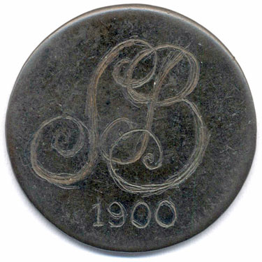 A bronze halfpenny coin which has been polished on both sides in order to produce a love token; on one side is engraved the cypher SB above the date 1800; on the other side is simply the letter D.