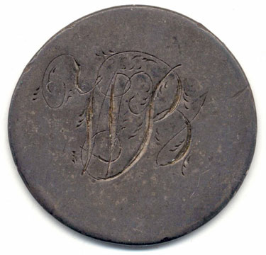 A silver George III (probably) coin which has been modified in order to produce a love token; on the reverse the cypher WB has been engraved; the obverse has had the original image of the monarch virtually erased, and is otherwise blank.