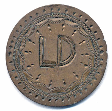 A bronze 1877 Queen Victoria halfpenny coin which has been modified in order to produce a love token; on one side are the letters LD within an ornamental border; the reverse has a worn but otherwise unaltered Britannia.