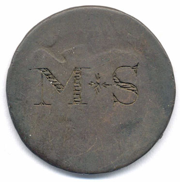 A bronze coin which has been smoothed to make a love token; the obverse still shows some of the monarch's (probably) head with the letters MS; the other side is blank. The style is very similar to that of KLMUS : 2010.73.58.