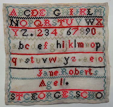 An unframed sampler signed Jane Roberts, Age 11. St George's School; mid to late Victorian; with alphabet and numbers.