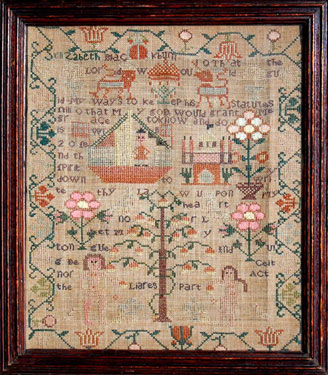 A framed sampler signed Elizabeth Blackburn. Elaborate design, religious text, Adam and Eve, Tree of Life, Noahs Ark, serpent, flowers, lion, unicorn, Noah's Ark, floral border.