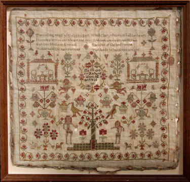 A framed sampler signed Mary Richardson 1830. Elaborately decorated including, religious text, Adam and Eve, Tree of Life, cherubs, birds, flowers, tree, floral border.